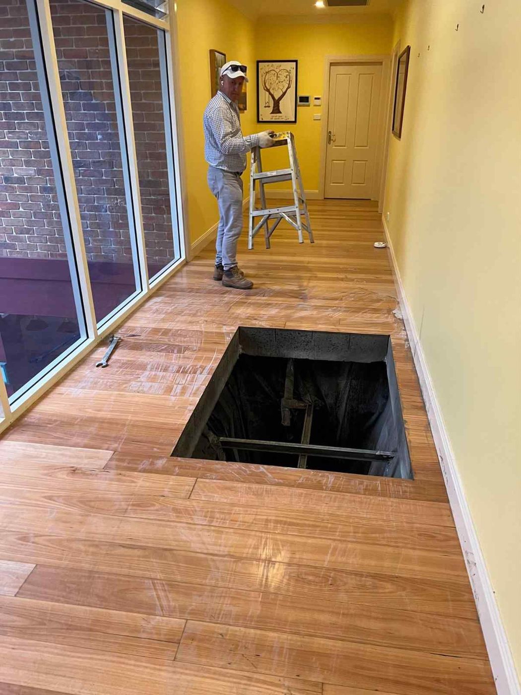 Floor opening beside a glazed wall in a finished home