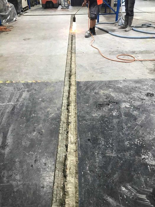 Long service trench cut through a warehouse floor