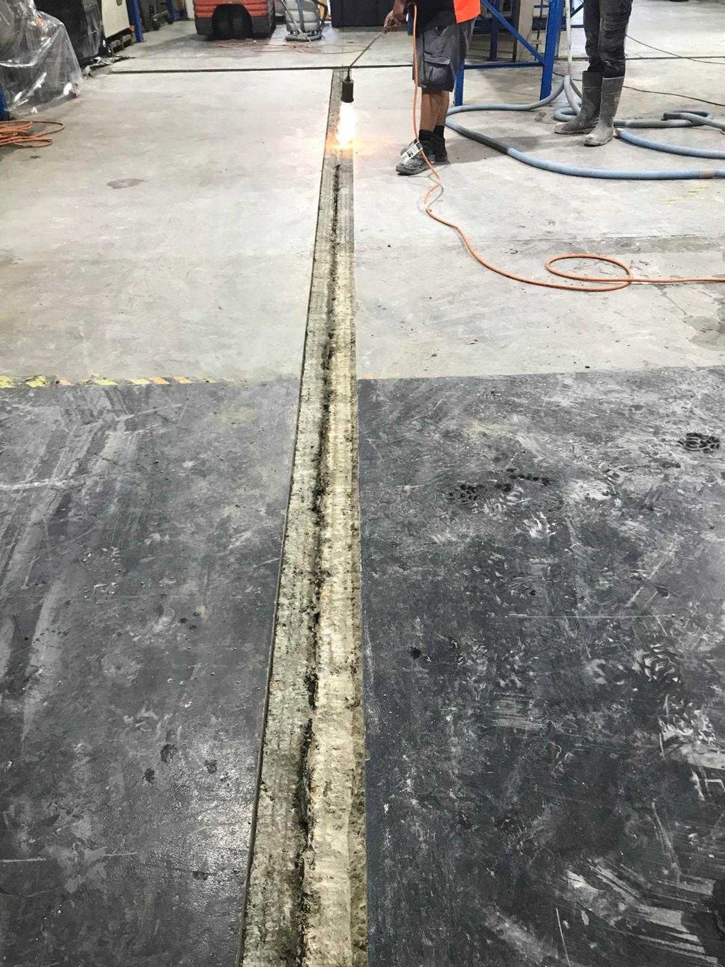 Long service trench cut through a warehouse floor