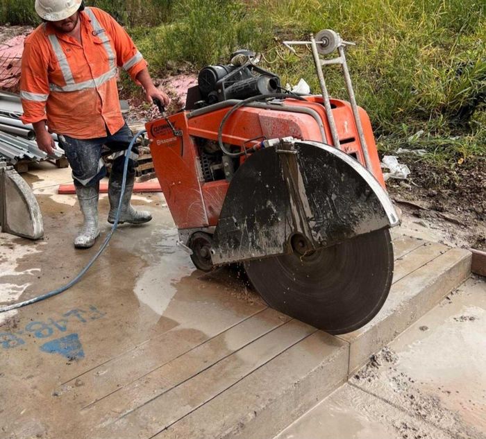 Walk-behind floor saw cutting an outdoor slab