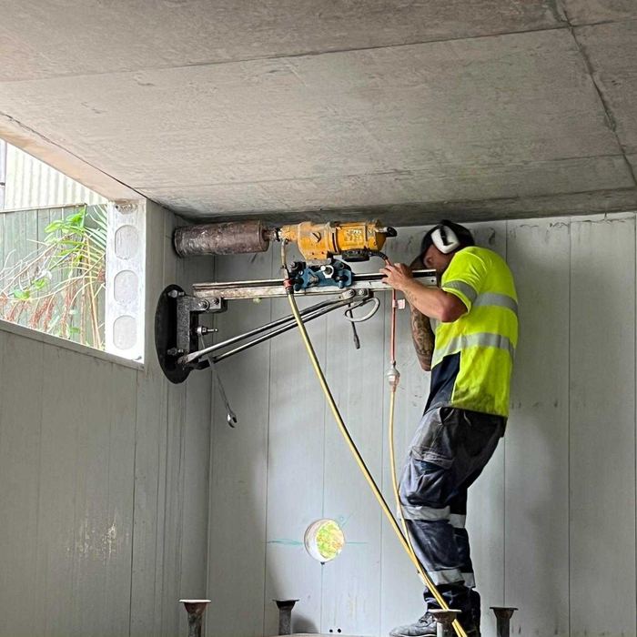 Core drill rig mounted on a wall